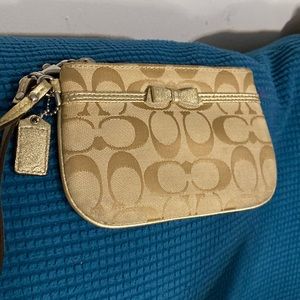 Signature coach canvas with a bow wristlet